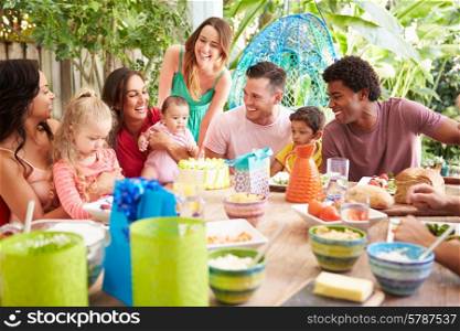 Group Of Families Celebrating Child&#39;s Birthday At Home
