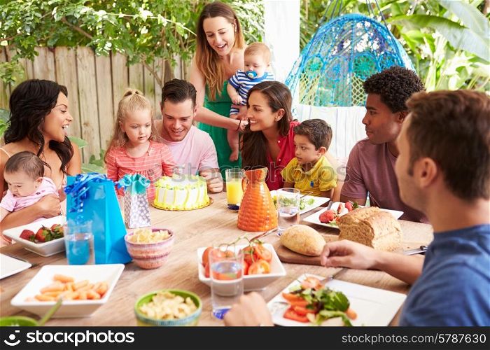 Group Of Families Celebrating Child&#39;s Birthday At Home