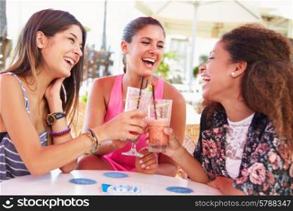 Group Of Female Friends Drinking Cocktails At Outdoor Bar