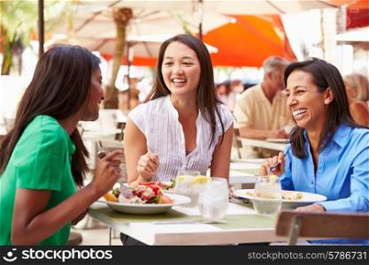 Group Of Female Friends Enjoying Lunch In Outdoor Restaurant