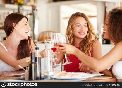 Group Of Female Friends Enjoying Meal In Outdoor Restaurant