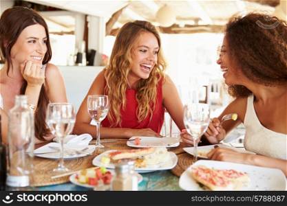 Group Of Female Friends Enjoying Meal In Outdoor Restaurant