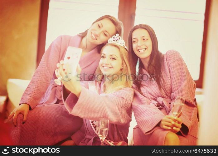 group of female friends in spa have fun and making selfie photo with mobile phone, celebrate bachelorette party. bachelorette party, making selfie