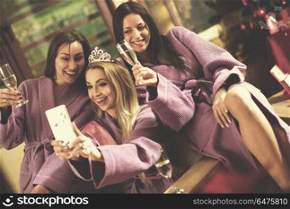 group of female friends in spa have fun and making selfie photo with mobile phone, celebrate bachelorette party. bachelorette party, making selfie