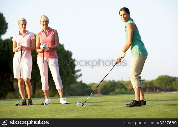 Group Of Female Golfers Teeing Off On Golf Course