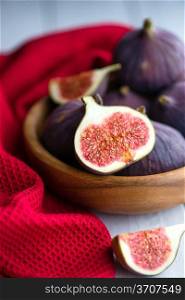Group of figs in a bowl and on rustic blue wooden table. Figs on rustic table