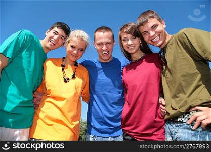 Group of five friends in multicolor shirts