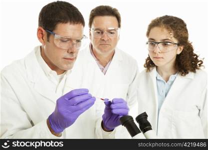 Group of forensic or medical scientists preparing a slide with human blood. Isolated on white.