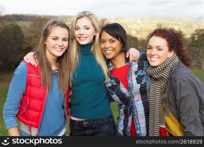 Group Of Four Teenage Female Friends In Autumn Landscape