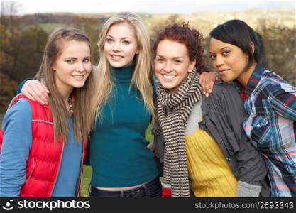 Group Of Four Teenage Female Friends In Autumn Landscape