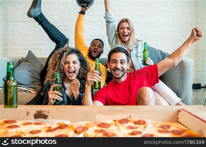Group of friends celebrating victory while watching a match together. Friends and sports concept.