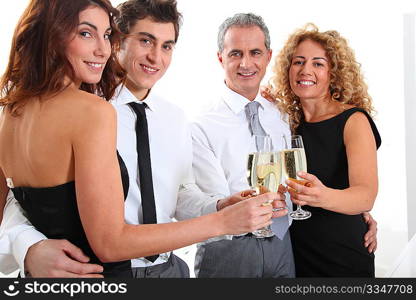 Group of friends cheering with glasses of champagne