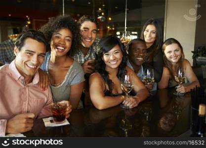 Group Of Friends Enjoying Drink At Bar Together