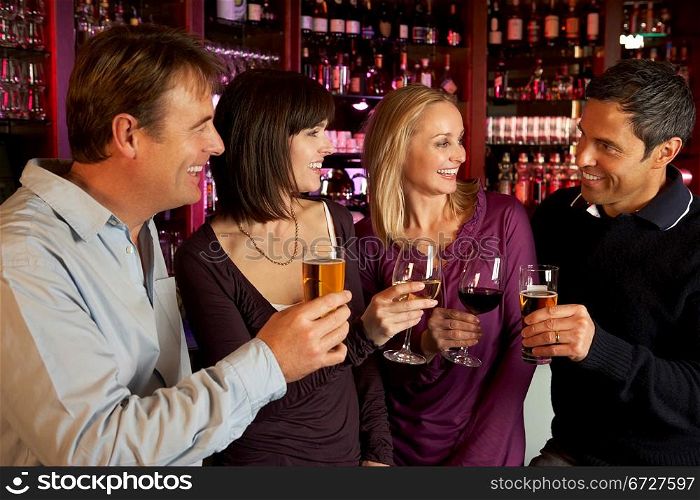 Group Of Friends Enjoying Drink Together In Bar