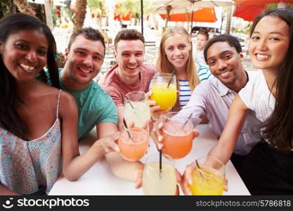 Group Of Friends Enjoying Drinks In Outdoor Restaurant