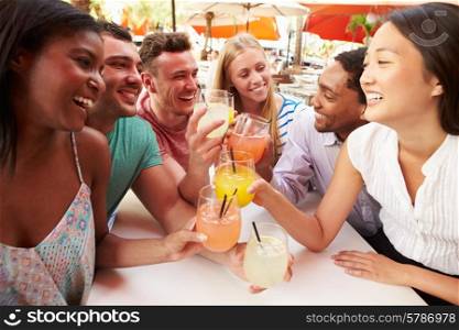 Group Of Friends Enjoying Drinks In Outdoor Restaurant