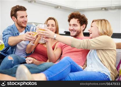 Group Of Friends Enjoying Glass Of Wine At Home