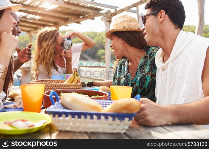 Group Of Friends Enjoying Lunch And Taking Photographs