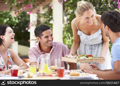 Group Of Friends Enjoying Meal outdoorss