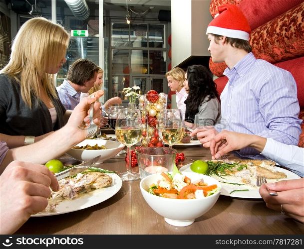 Group of friends enjoying their christmas dinner in a restaurant
