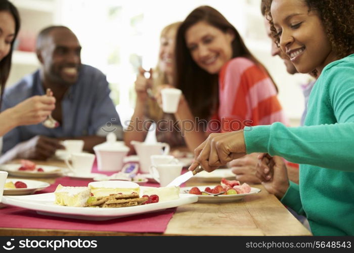 Group Of Friends Having Cheese And Coffee Dinner Party