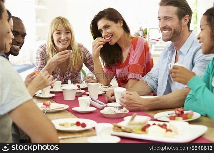 Group Of Friends Having Cheese And Coffee Dinner Party