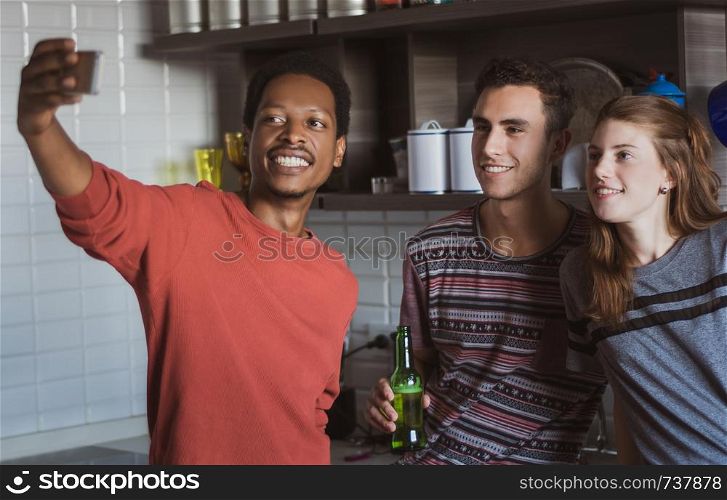 Group of friends having fun and making a selfie at home.