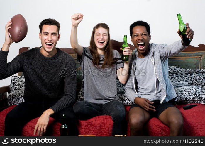 Group of friends having fun at home, watching game and Celebrating Goal.