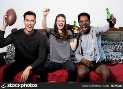 Group of friends having fun at home, watching game and Celebrating Goal.