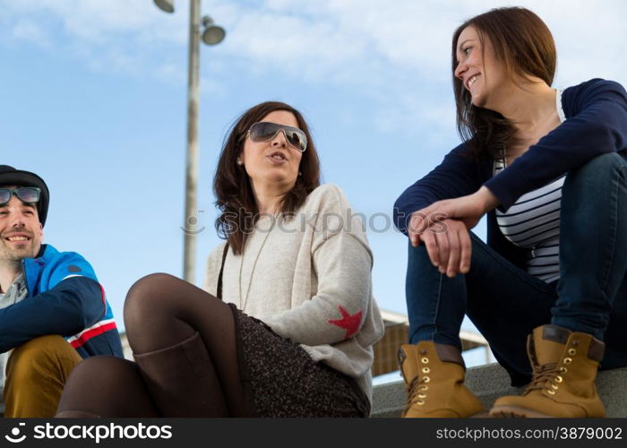 Group of friends having fun in a park at sunset