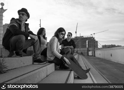 Group of friends having fun in a park at sunset