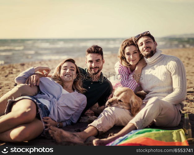 Group of friends having fun on beach during autumn day. Group Of Young Friends Spending The Day On A Beach during autumn day colored filter