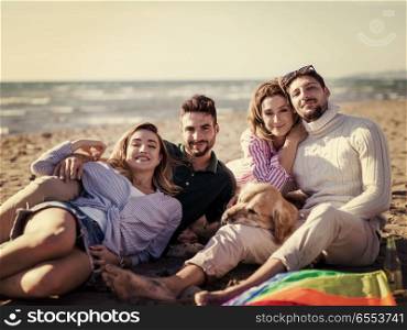 Group of friends having fun on beach during autumn day. Group Of Young Friends Spending The Day On A Beach during autumn day colored filter