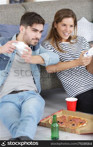 group of friends having fun playing video games at home