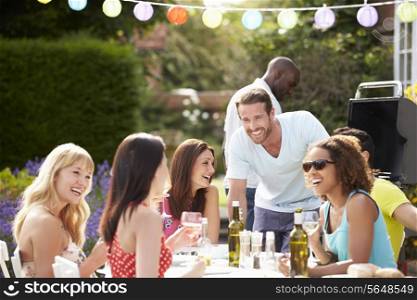 Group Of Friends Having Outdoor Barbeque At Home