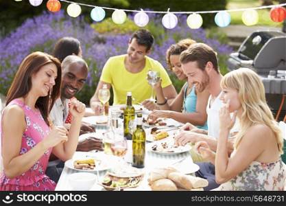 Group Of Friends Having Outdoor Barbeque At Home