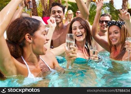 Group Of Friends Having Party In Pool Drinking Champagne