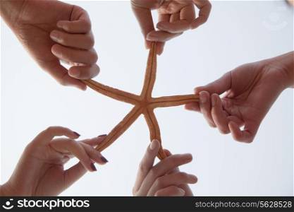 Group of Friends Holding a Starfish