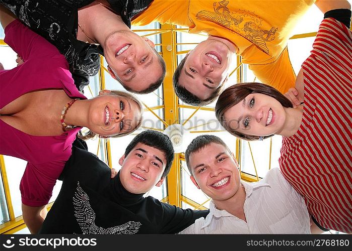 group of friends it smiling after being embraced into the circle it looks downward