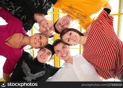 group of friends it stands smiling after being embraced into circle it looks downward