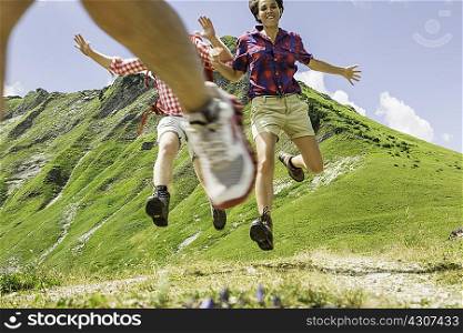 Group of friends jumping, Tyrol, Austria