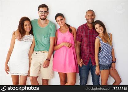 Group Of Friends Leaning Against White Wall
