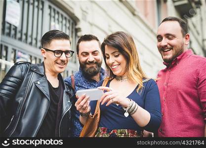 Group of friends looking at message on cellphone