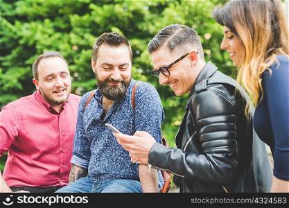 Group of friends looking at message on cellphone