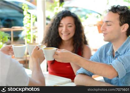 Group of friends meeting, drinking coffee and enjoying together in a coffee shop. Relaxing Together.