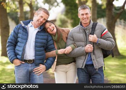 Group Of Friends On Walk In Autumn Park Together