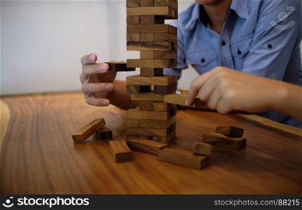 Group of Friends playing blocks wood game on the table folded puzzle