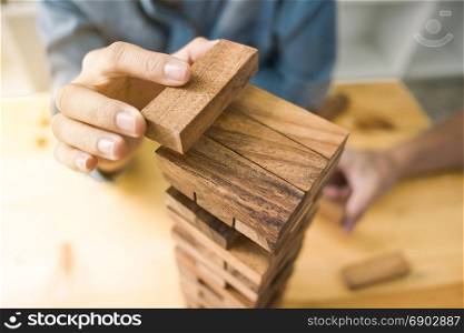 group of friends playing game wooden blocks, business start up building, risk and growth concept