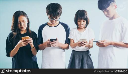 Group of friends playing smart phones .Concept of teenagers or youth addiction to new technology and social app trends .