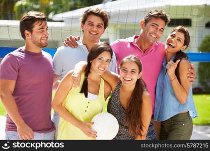 Group Of Friends Playing Volleyball In Garden